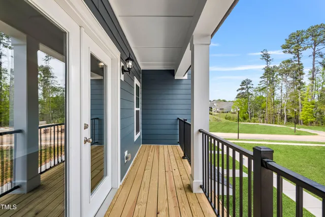 a view of a balcony with wooden floor