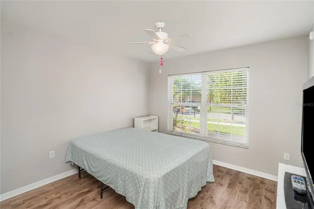 a bedroom with a bed and a window