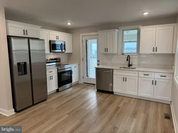 a kitchen with stainless steel appliances a refrigerator microwave and stove