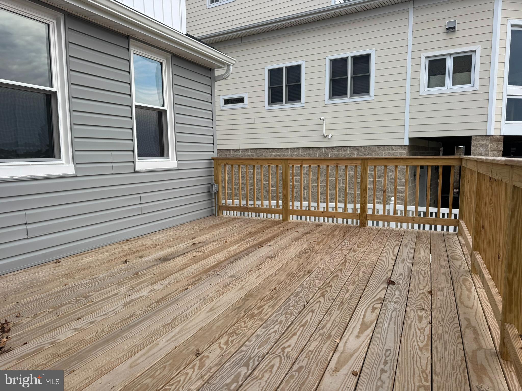 9135 Cuckold Point Road Sparrows Point, MD 21219 - Photo 12 of 53 a view of a wooden deck with a barbeque