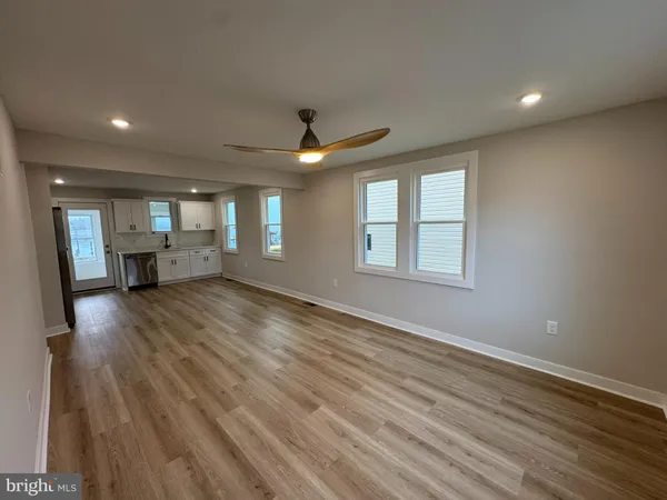 a view of a kitchen with a sink cabinets and wooden floor