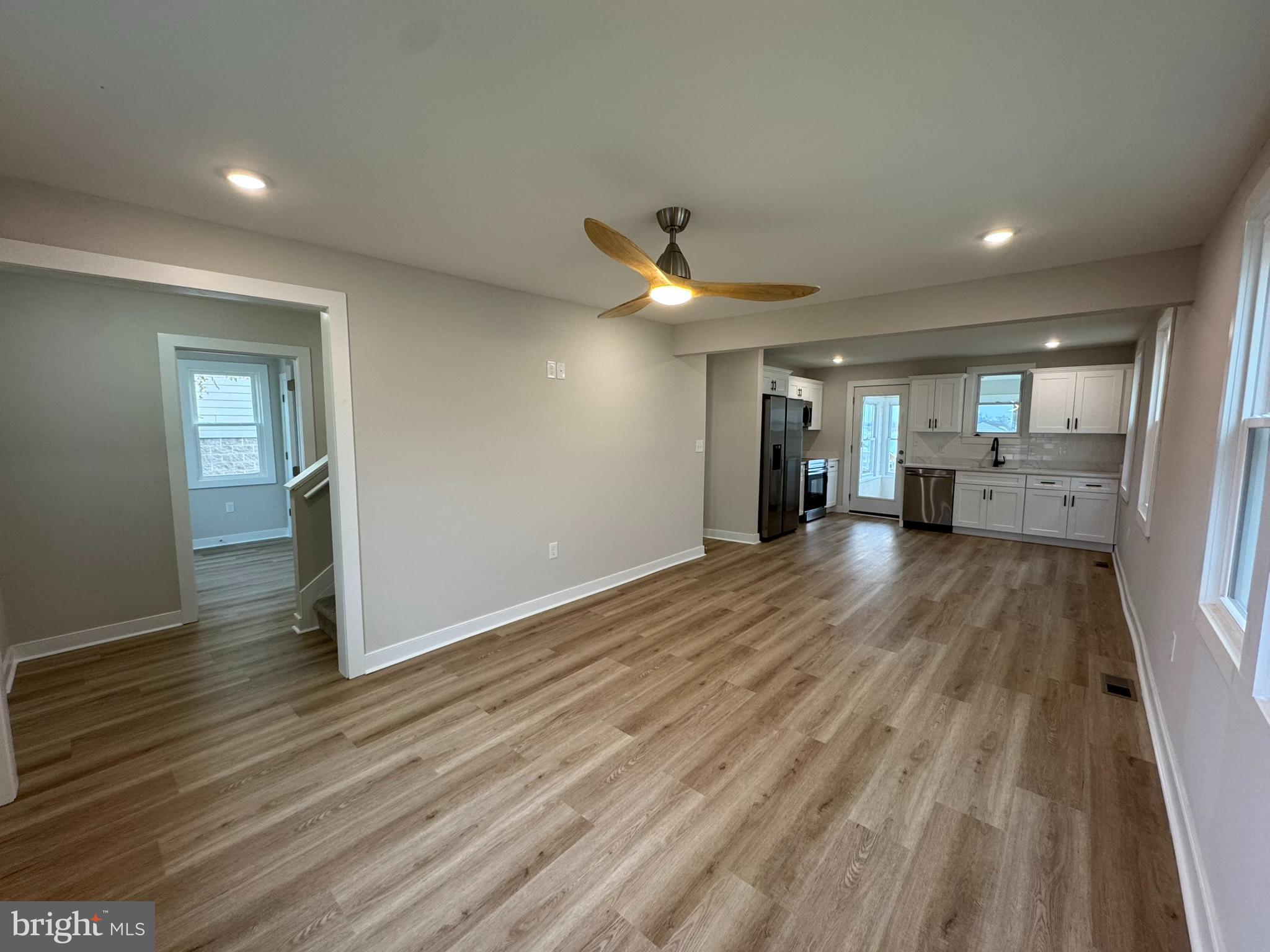 9135 Cuckold Point Road Sparrows Point, MD 21219 - Photo 19 of 53 a view of a big room with wooden floor and a kitchen