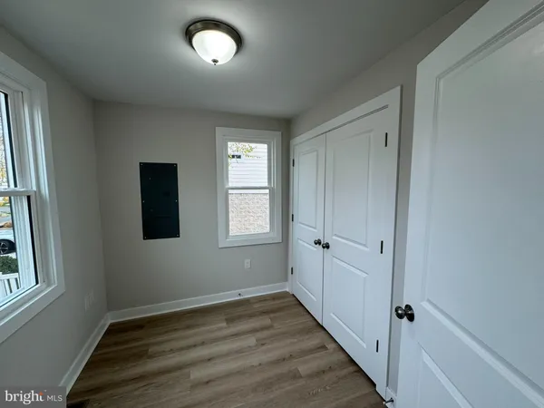 a view of a closet area with furniture and wooden floor