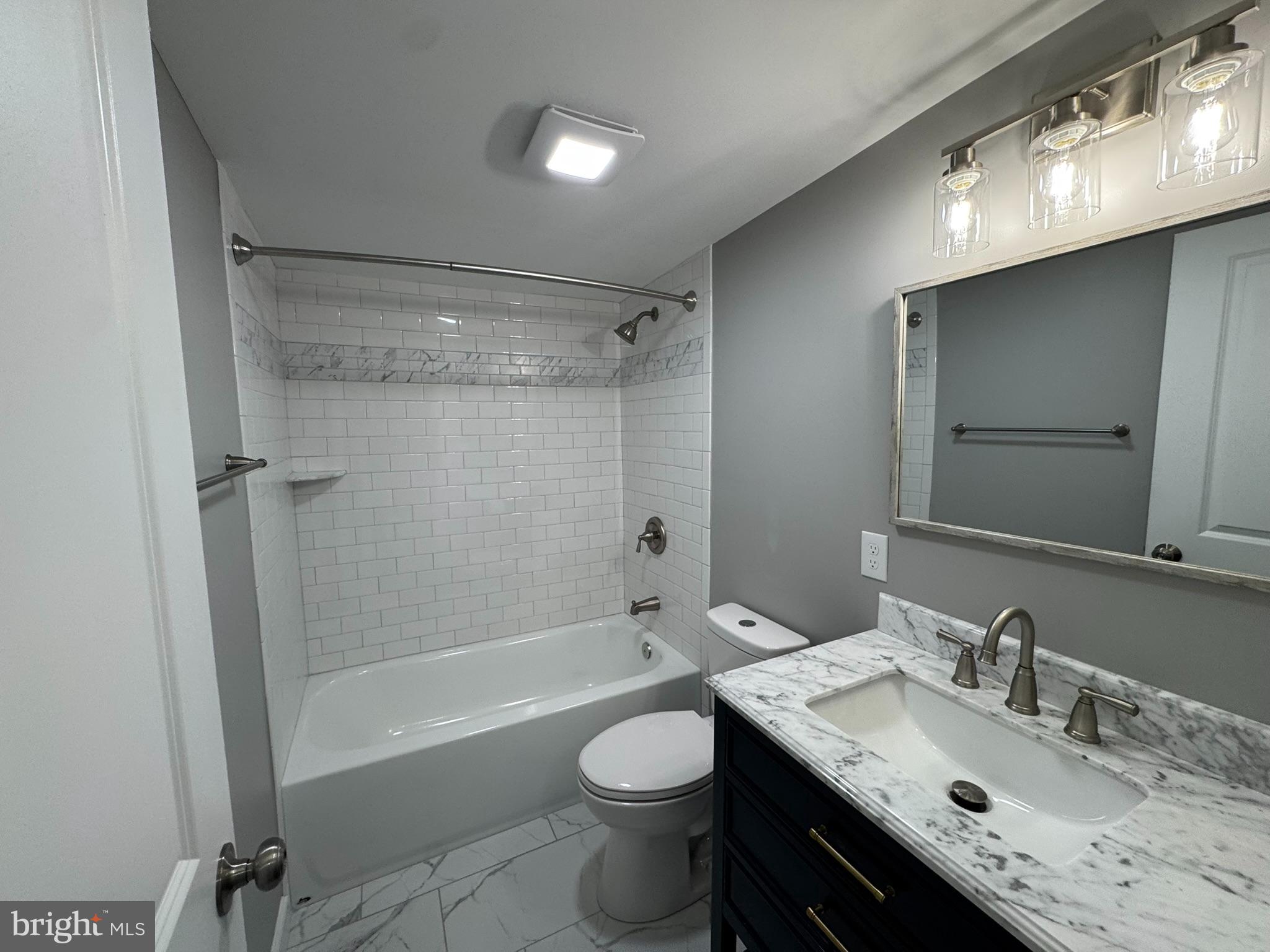 9135 Cuckold Point Road Sparrows Point, MD 21219 - Photo 45 of 53 a bathroom with a granite countertop sink toilet and shower