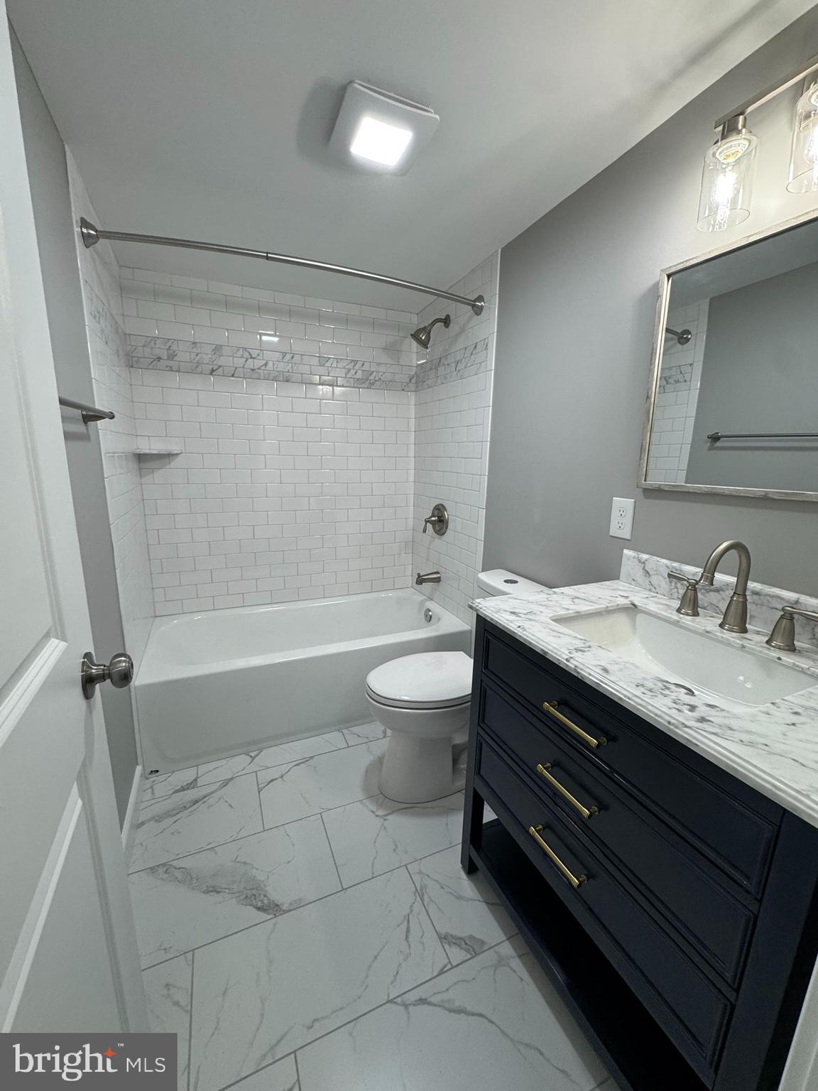 9135 Cuckold Point Road Sparrows Point, MD 21219 - Photo 46 of 53 a bathroom with a granite countertop sink a toilet and shower
