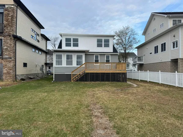a view of a house with a yard and many windows