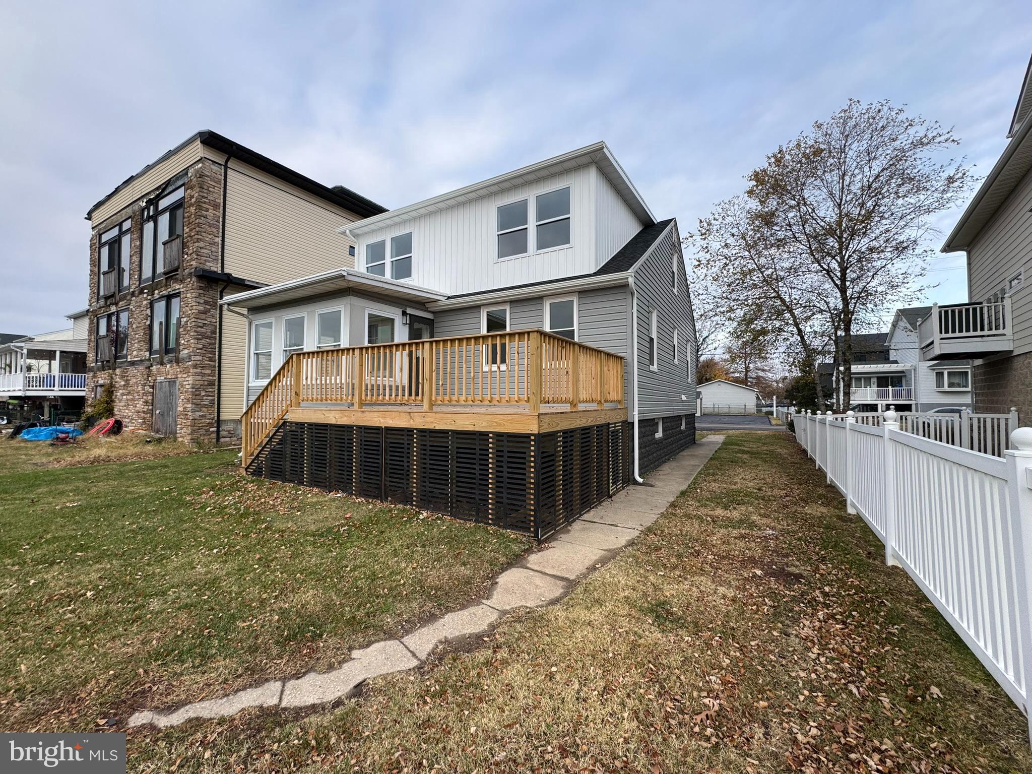 9135 Cuckold Point Road Sparrows Point, MD 21219 - Photo 10 of 53 a view of a house with a yard and many windows