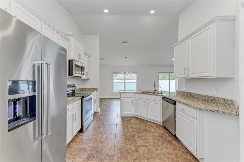 105 Dartmouth Road Venice, FL 34293 - Photo 13 of 100 a large kitchen with stainless steel appliances granite countertop a stove a sink dishwasher and a refrigerator