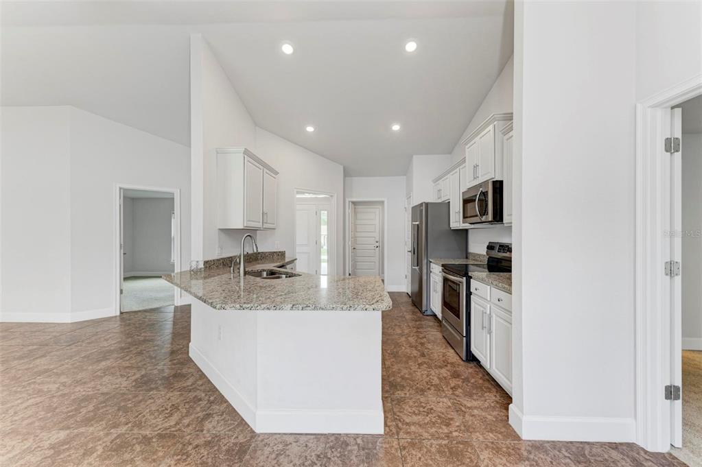 105 Dartmouth Road Venice, FL 34293 - Photo 15 of 100 a large kitchen with stainless steel appliances granite countertop a large counter top a stove and a refrigerator