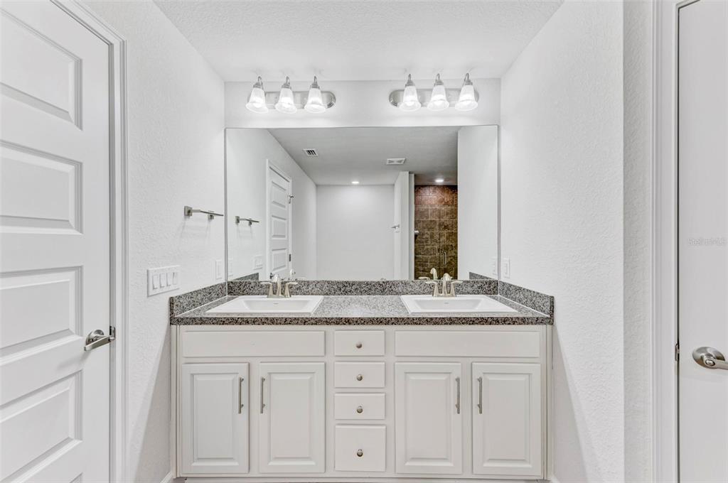 105 Dartmouth Road Venice, FL 34293 - Photo 22 of 100 a bathroom with a granite countertop sink and a mirror