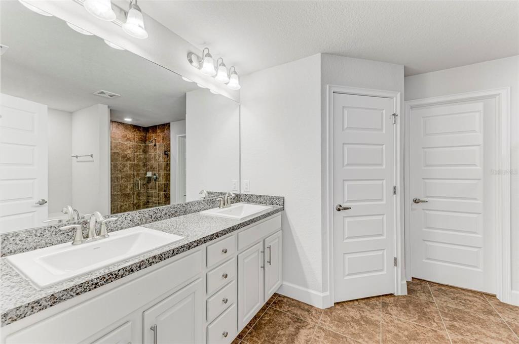 105 Dartmouth Road Venice, FL 34293 - Photo 27 of 100 a spacious bathroom with a granite countertop sink a mirror and a shower