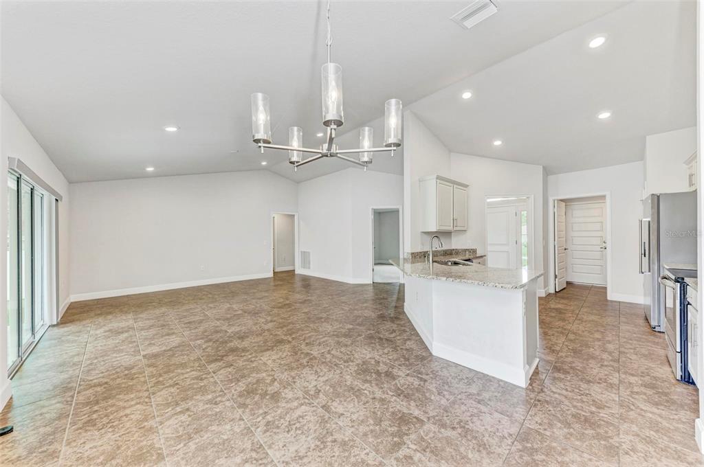 105 Dartmouth Road Venice, FL 34293 - Photo 9 of 100 a large kitchen with kitchen island white cabinets and stainless steel appliances