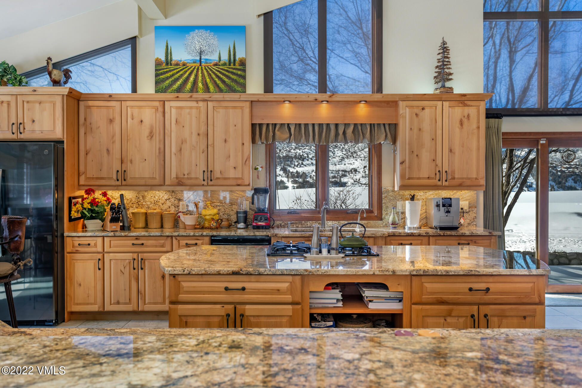231 Rawhide Road Edwards, CO 81632 - Photo 10 of 35 a kitchen with granite countertop wooden cabinets and a sink