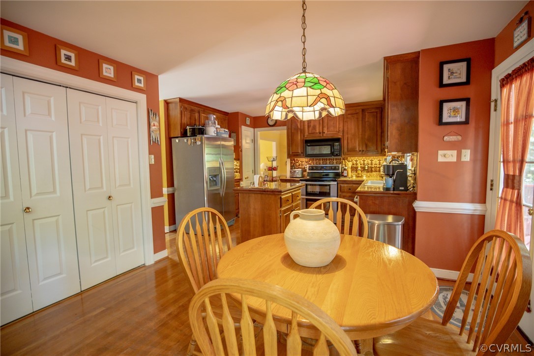 13340 Carters Way Road Chesterfield, VA 23838 - Photo 9 of 44 a view of a dining room with furniture a chandelier and wooden floor