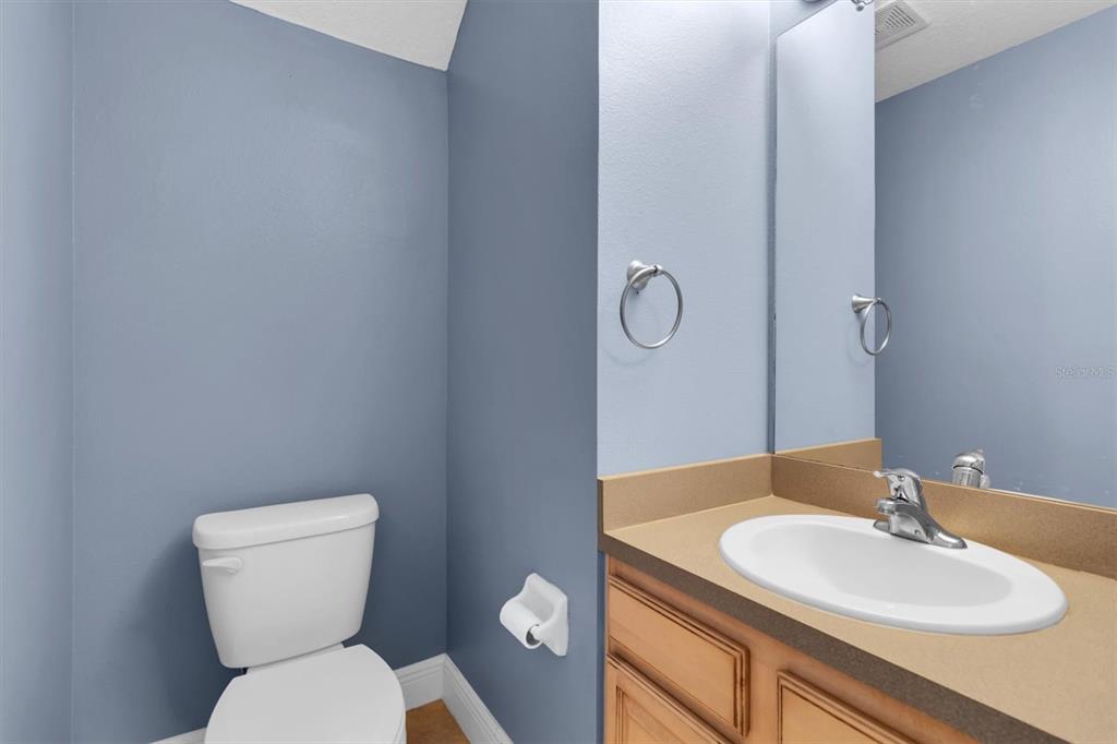 10121 Porch Street New Port Richey, FL 34655 - Photo 19 of 57 a bathroom with a toilet sink and mirror