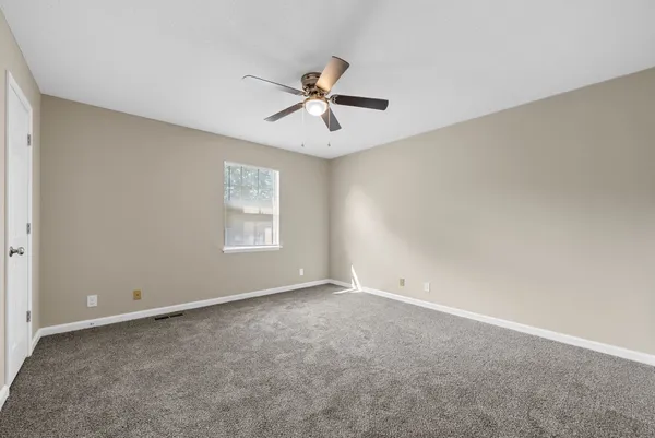 a view of an empty room with a window