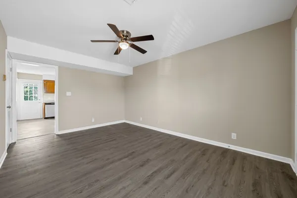 wooden floor in an empty room with a window