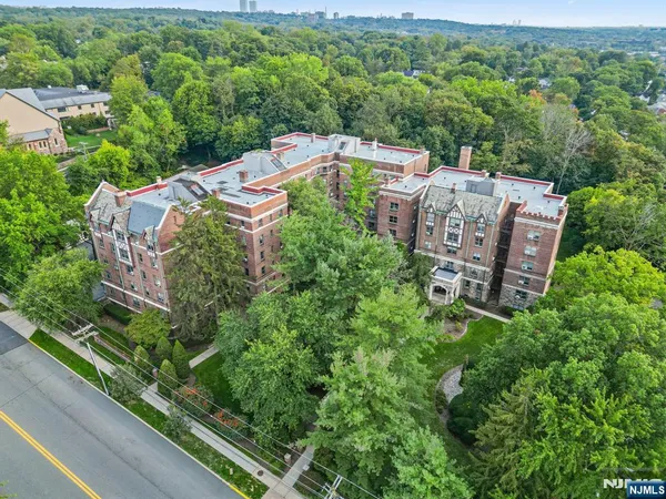 an aerial view of a house with a yard and lake view