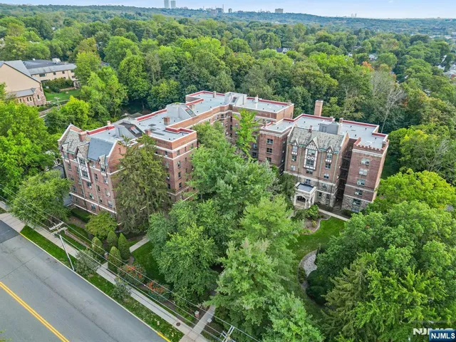 an aerial view of a house with a yard and lake view