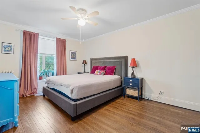 a bedroom with a bed and a large window