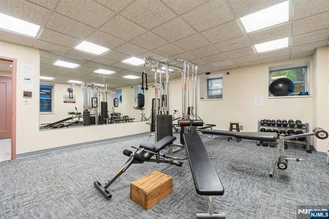 a room with gym equipment and view of living room