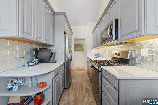 a kitchen with kitchen island a stove a sink and a refrigerator