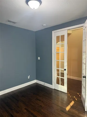 a view of a room with wooden floor