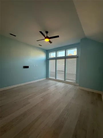 an empty room with a empty space and a ceiling fan