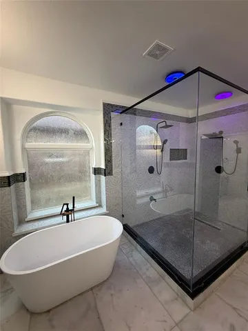 a bathroom with a shower a mirror and a shower