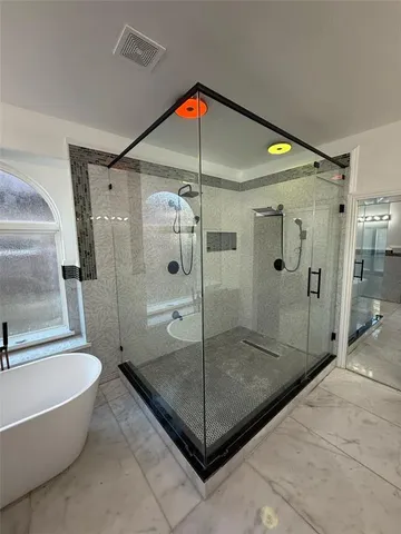 a bathroom with a shower and a bathtub