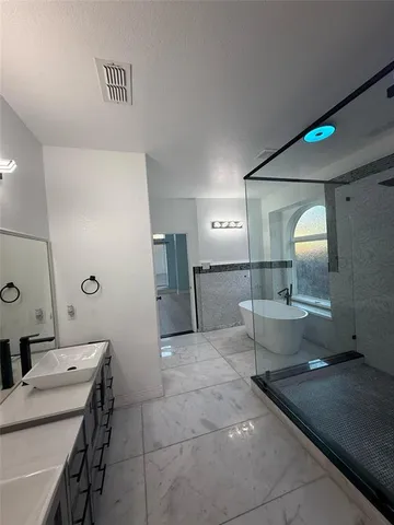 a spacious bathroom with a sink and a mirror