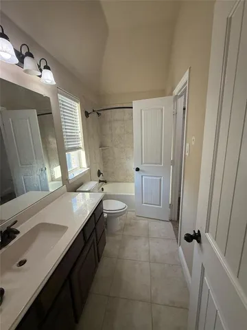 a bathroom with a double vanity sink toilet and shower