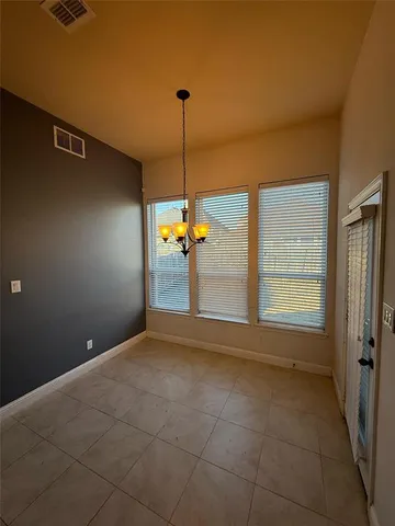 a kitchen with kitchen island a sink stainless steel appliances and a counter top space
