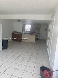 1480 Northeast 151st Street, Unit 101 North Miami Beach, FL 33162 - Photo 2 of 4 a living room with a washing machine and a sink