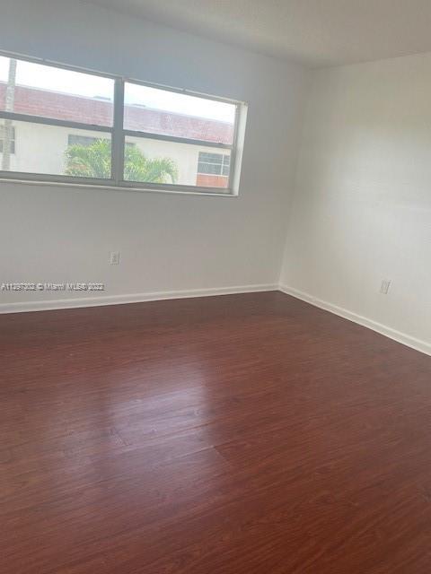 1480 Northeast 151st Street, Unit 101 North Miami Beach, FL 33162 - Photo 3 of 4 an empty room with a window