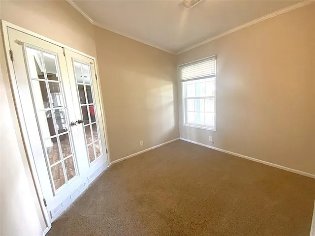 an empty room with a empty space and windows