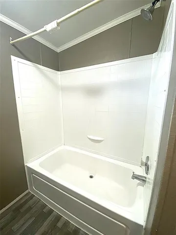 a view of a hallway with furniture and wooden floor