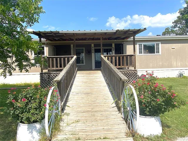 a view of a house with wooden deck