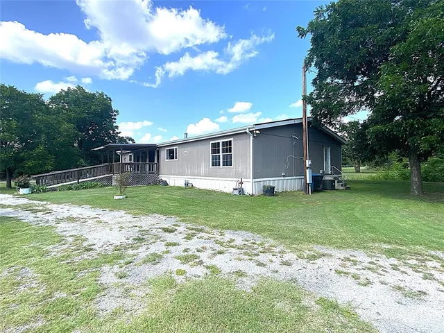 a view of a house with a backyard