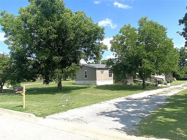 a view of a backyard of the house