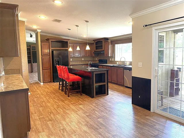 a kitchen with stainless steel appliances granite countertop a stove and refrigerator