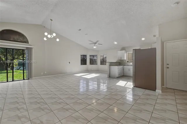 a very nice looking room with a large window and chandelier