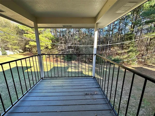 a view of balcony with wooden floor