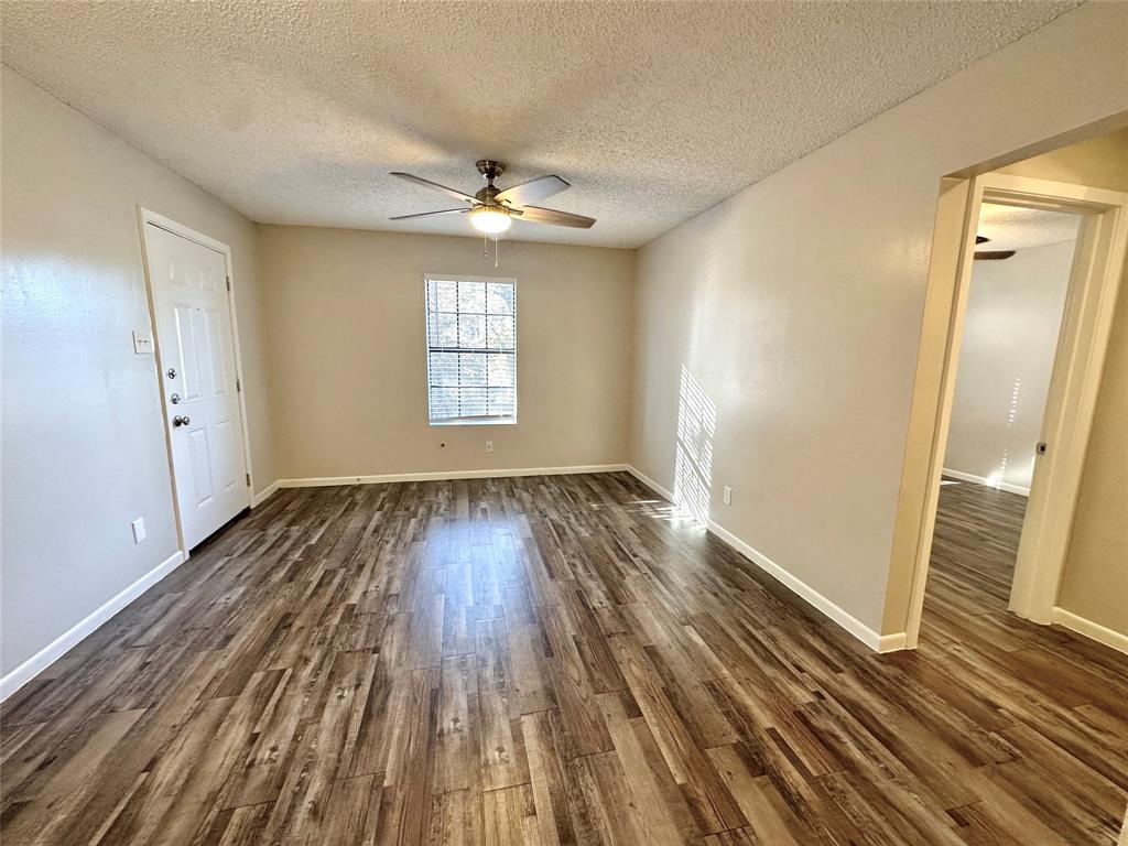 2006 Jane Street, Unit C Longview, TX 75601 - Photo 4 of 12 wooden floor in an empty room with a window