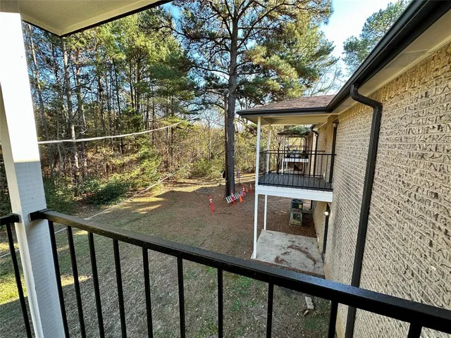 a view of balcony with wooden floor and fence