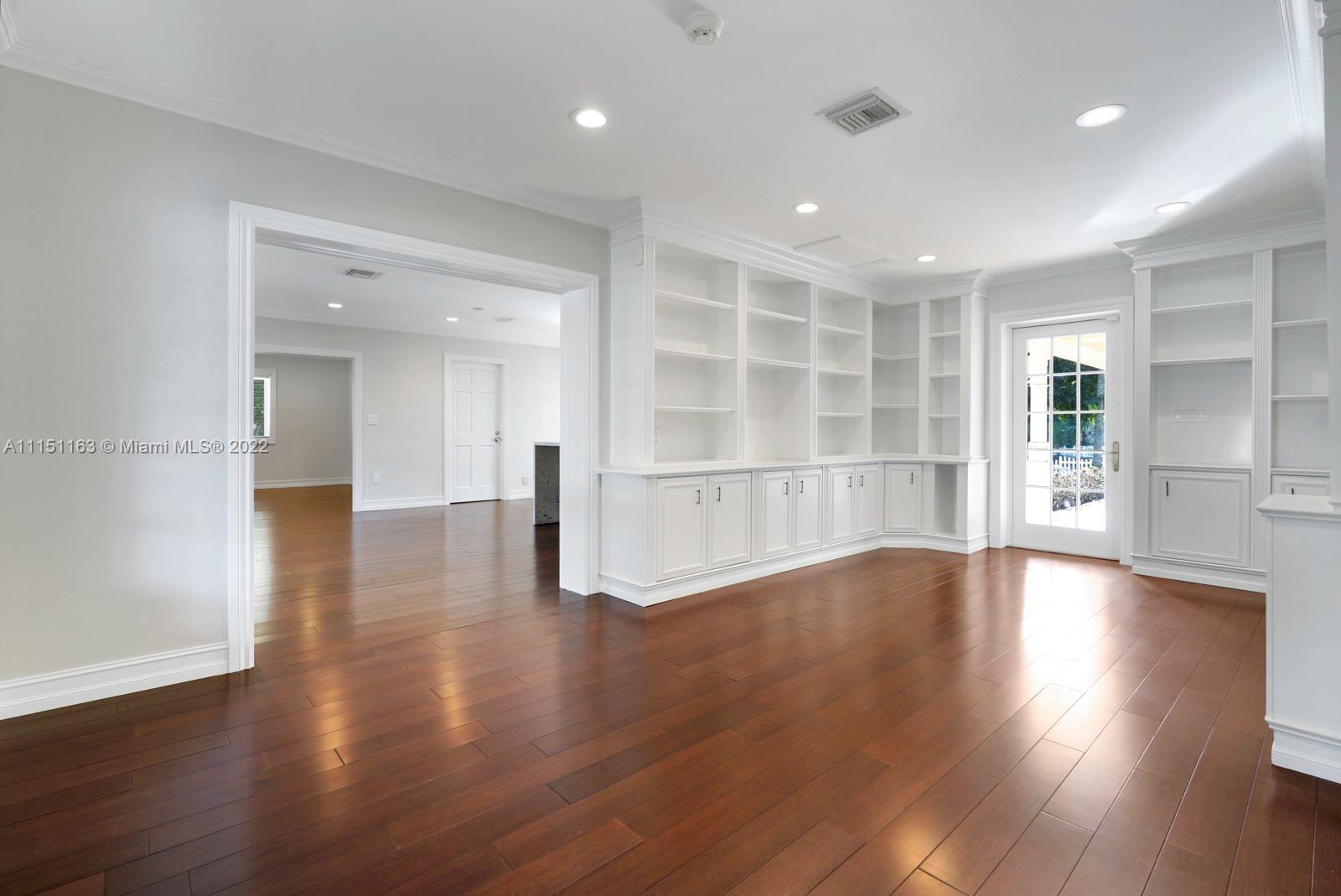 13920 Stirling Road Southwest Ranches, FL 33330 - Photo 13 of 98 a view of empty room with wooden floor and kitchen view