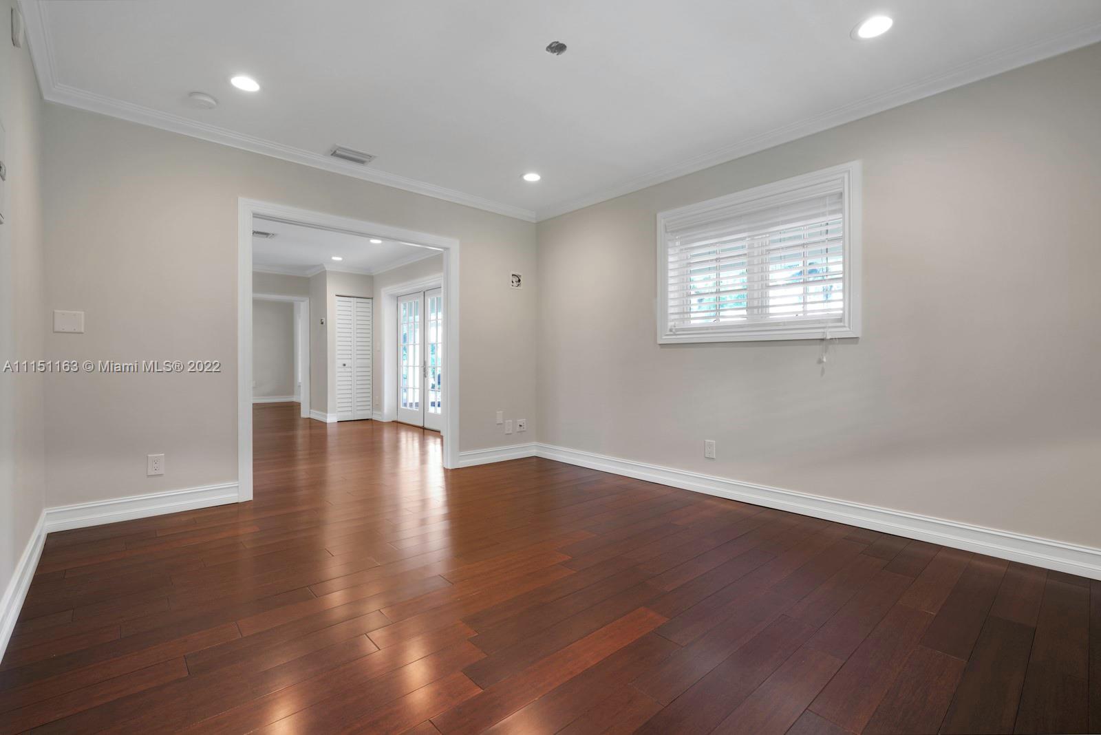 13920 Stirling Road Southwest Ranches, FL 33330 - Photo 22 of 98 an empty room with wooden floor and windows