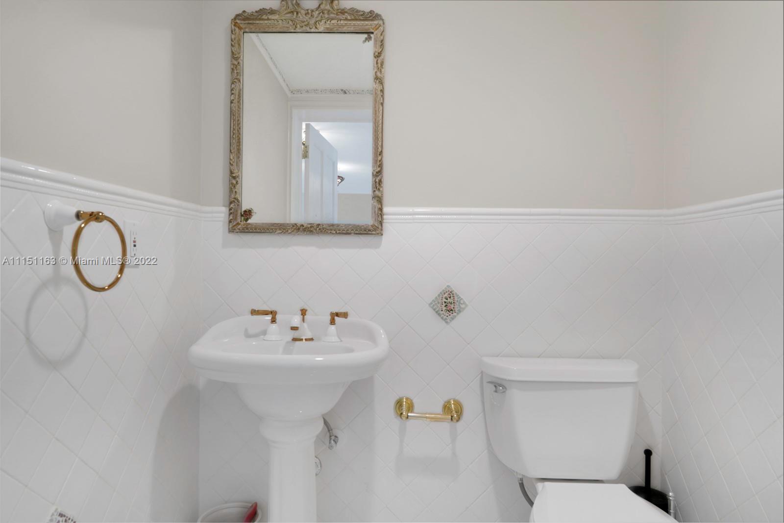 13920 Stirling Road Southwest Ranches, FL 33330 - Photo 24 of 98 a bathroom with a toilet sink and mirror