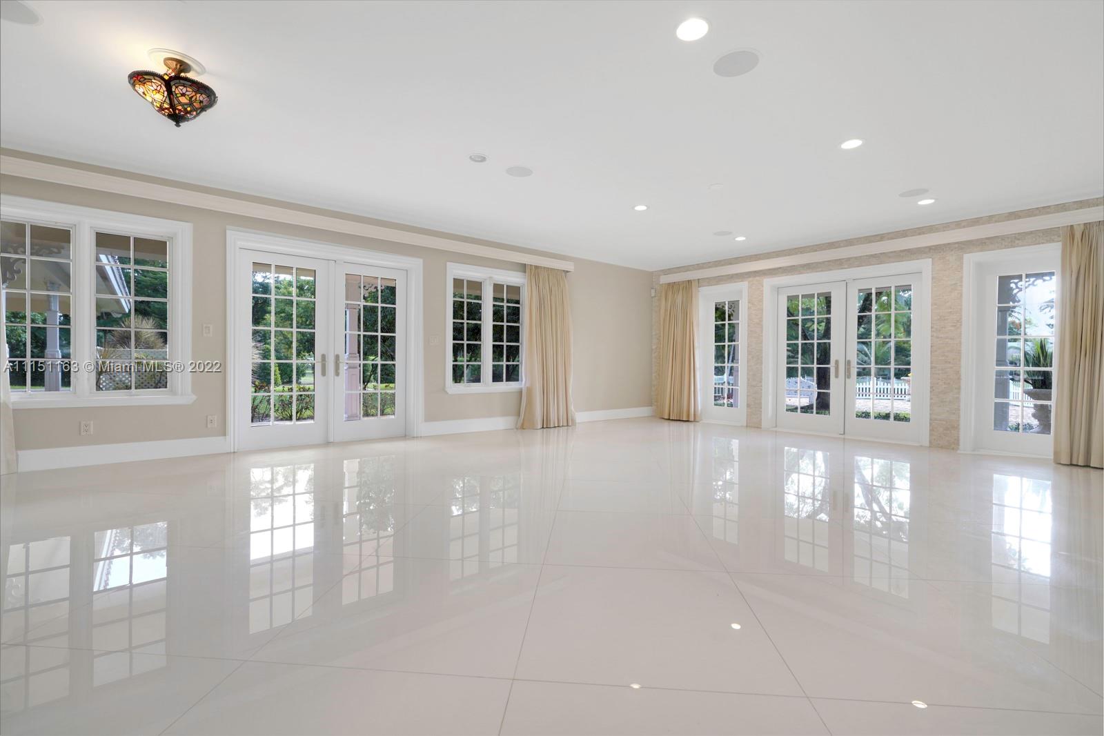 13920 Stirling Road Southwest Ranches, FL 33330 - Photo 25 of 98 a view of an entryway with wooden floor and garden view