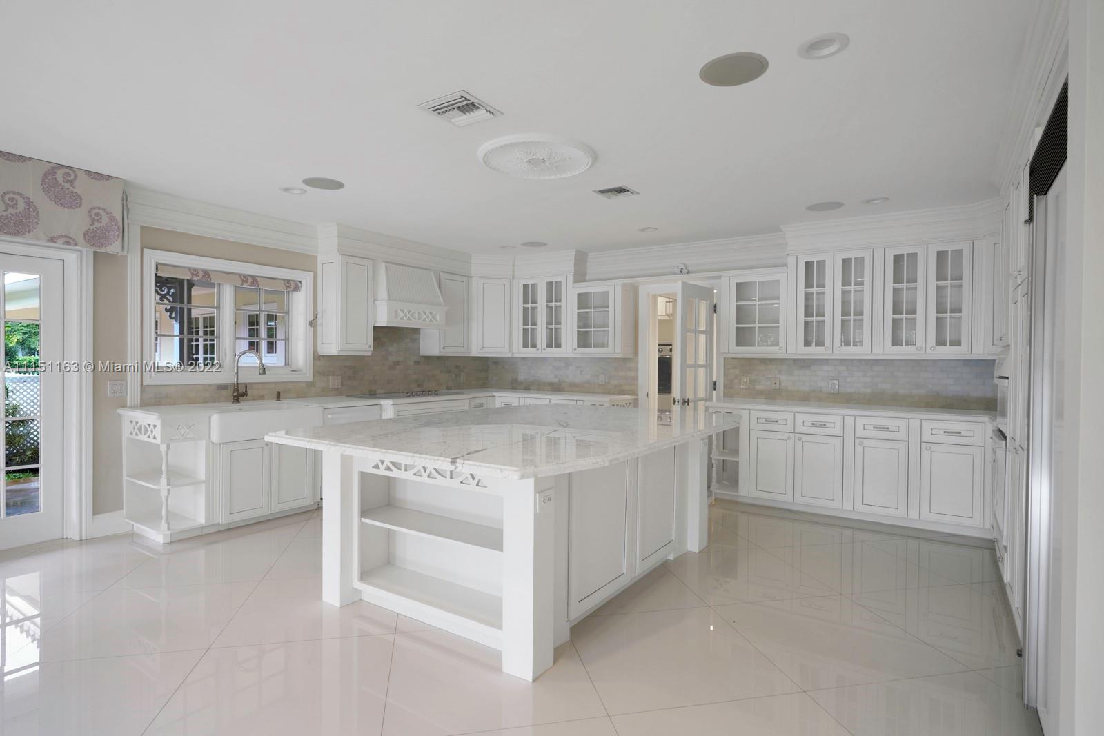 13920 Stirling Road Southwest Ranches, FL 33330 - Photo 27 of 98 a kitchen with white cabinets and white appliances